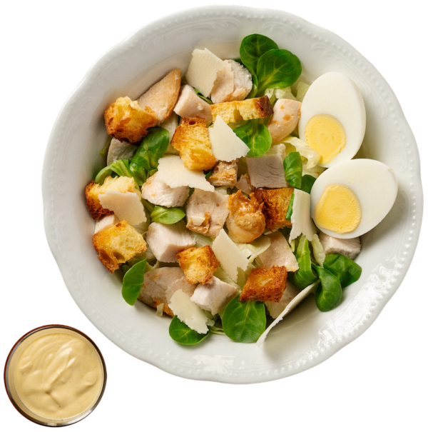 Poorcaesar salad (valerian, lettuce, chicken, hard-boiled egg, croutons, grana flakes) served with croutons