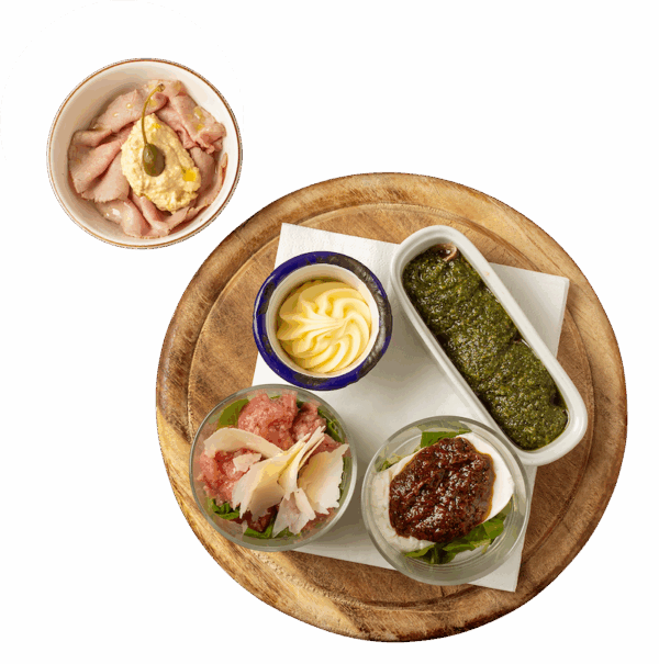 Selection of Piedmontese starters (anchovies, raw sausage, ,veal with tuna sauce, tomino cheese)